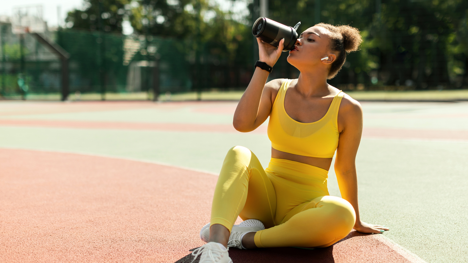 woman drinking from the best protein shaker after her workout