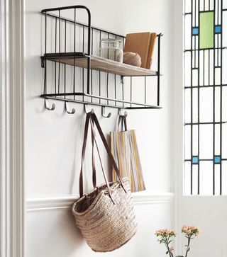 hallway with hooks storage and white wall