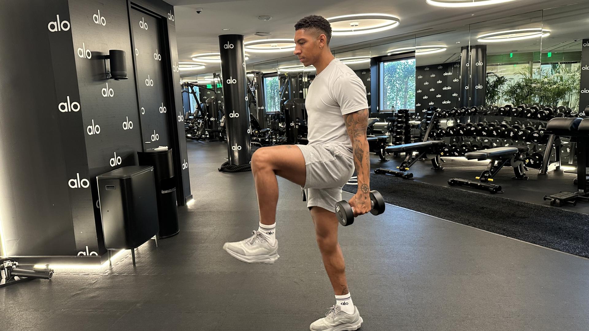 Man exercising with dumbbells in gym