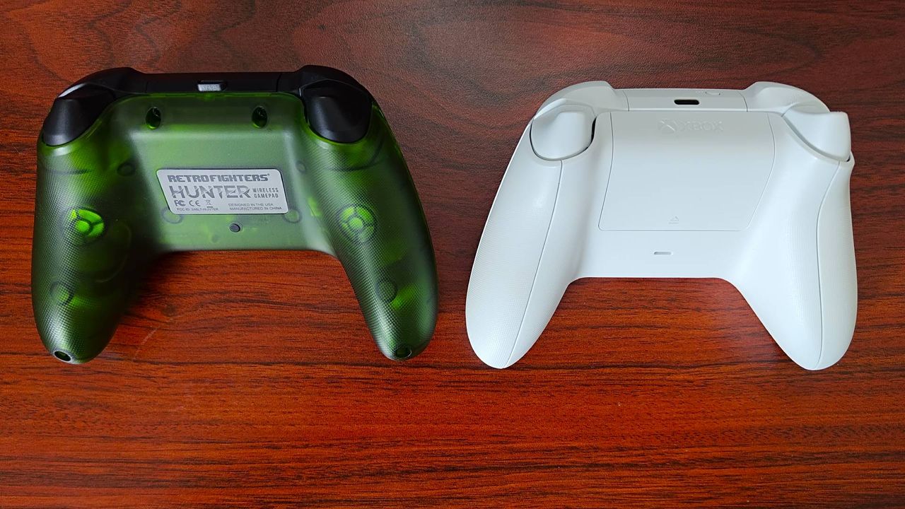 Back views of Retro Fighters Hunter and Xbox Wireless Controller in Robot White sitting on woodgrain desk.