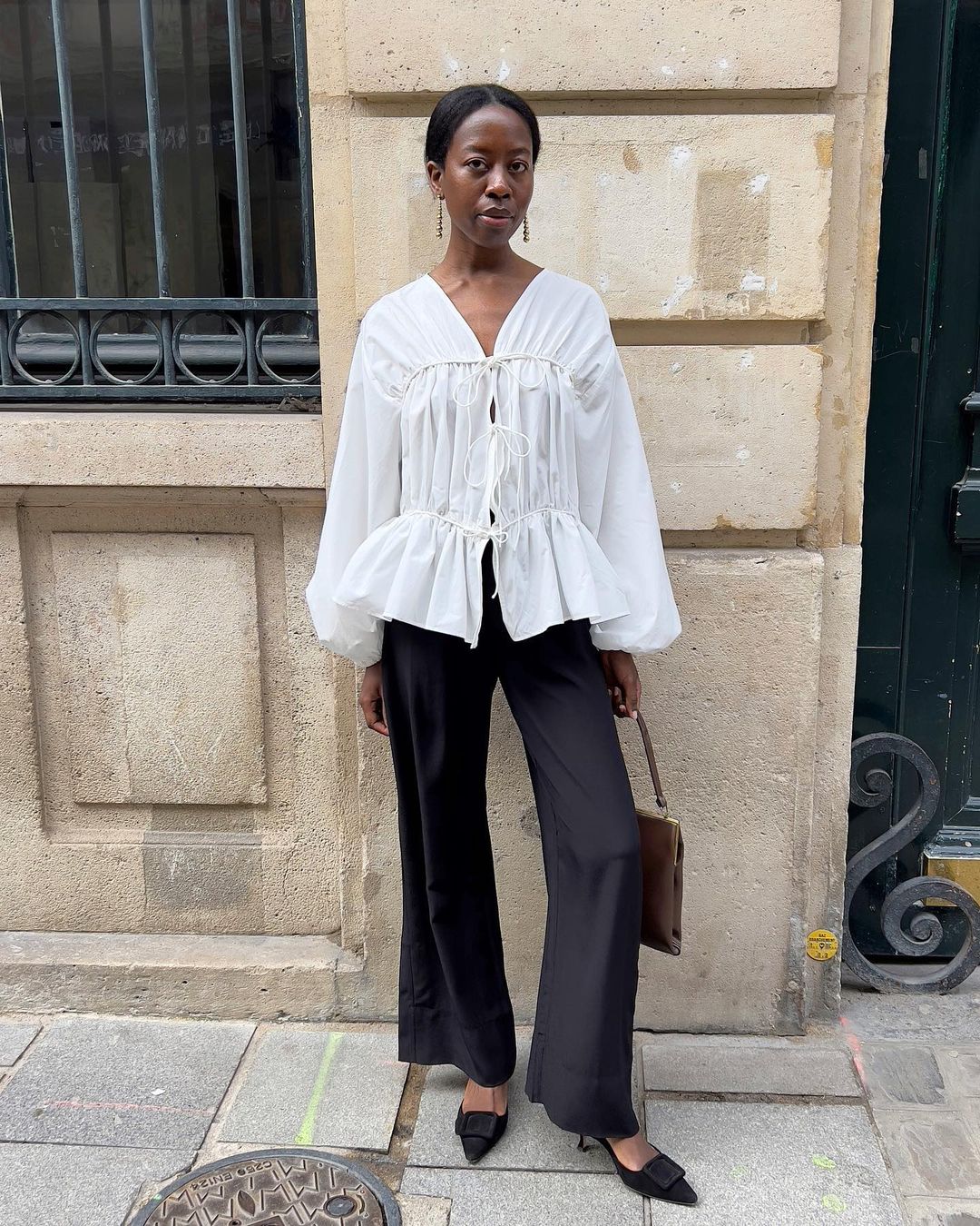 @sylviemus_ wearing dangling earrings with trousers and shirt