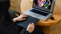 Illustrator using Wacom Intuos Pro (2025) with a laptop on a coffee table 