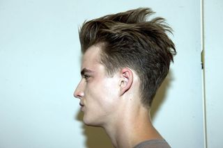 profile shot of male model looking to the left with short styled hair