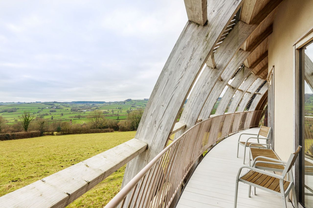 The balcony shows the surrounding landscape and is made from beach timber
