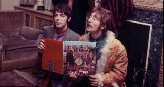 The Beatles pose for the press with their newly completed album, 'Sergeant Pepper's Lonely Hearts Club Band', at the press launch for the album, held at manager Brian Epstein's house at 24 Chapel Street, London, 19th May 1967. Clockwise from top left: Ringo Starr, George Harrison (1943 - 2001), John Lennon (1940 - 1980) and Paul McCartney. 