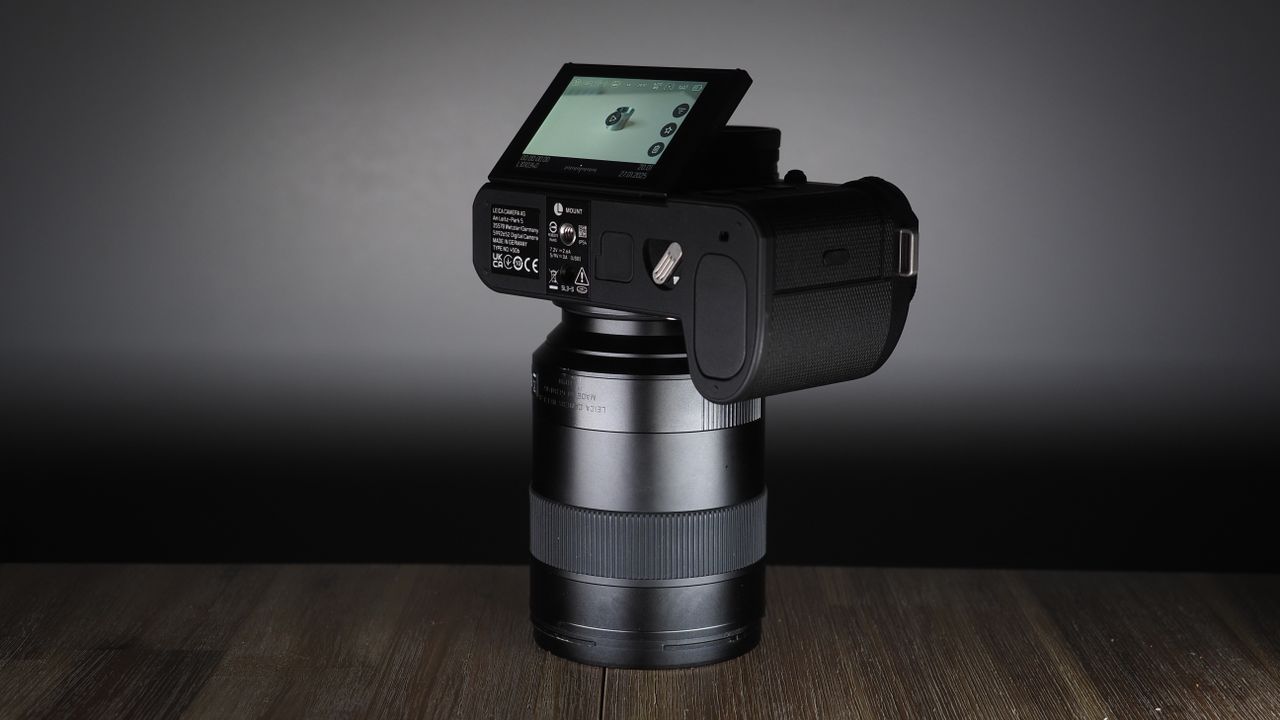 Leica SL3-S on a wooden surface with moody lighting