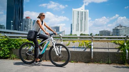 Woman cycling e bike in the city 