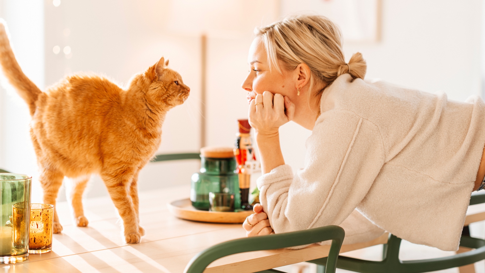 Woman and cat looking into each other's eyes