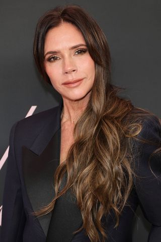 Victoria Beckham is pictured with long, wavy 'Hourglass layers' whilst attending the premiere of "Lola" at Regency Bruin Theatre on February 03, 2024 in Los Angeles, California.