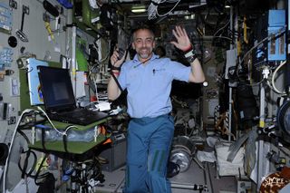 Does this man own part of the moon? Entrepreneur Richard Garriott flies high aboard the International Space Station in 2008.