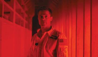 Ad Astra Brad Pitt bathed in red light