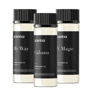 Three bottles of essential oils with black labels and black plastic lids