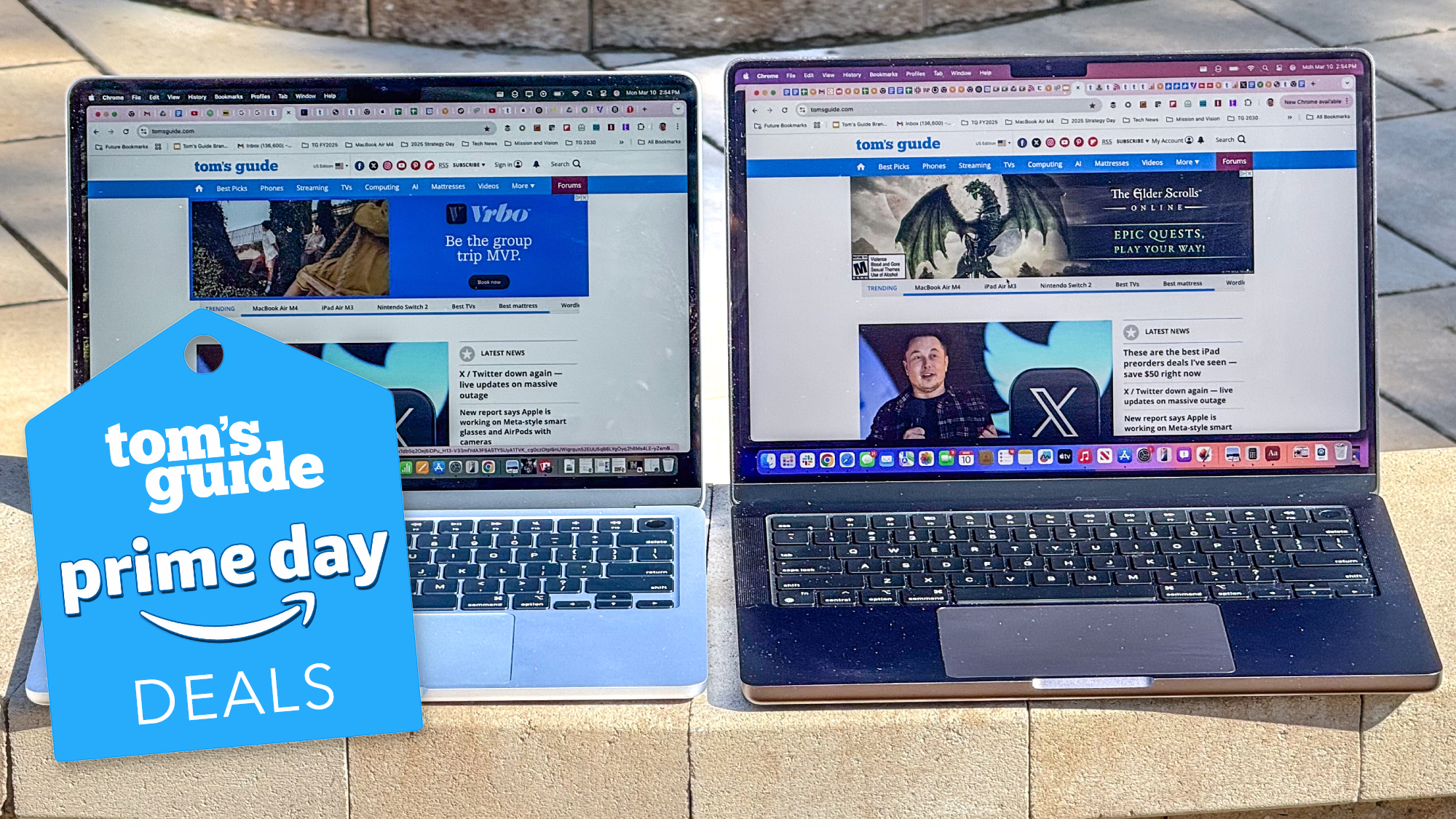 MacBooks on a curb with Tom's Guide Prime Day deal tag superimposed