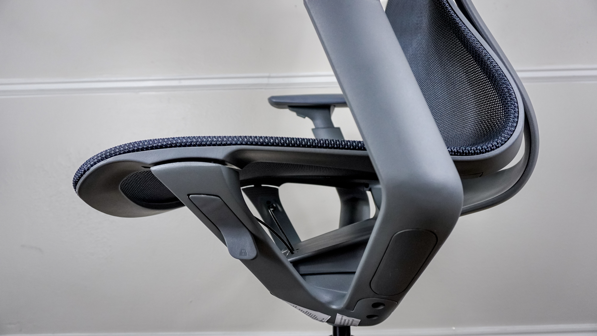 A side view of the underside of the Branch Aire Chair&#039;s seat showing off the adjustment tab used for reclining