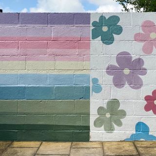 Colourful stripes and flowers painted on exterior wall
