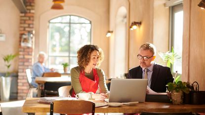 A small business woman works with a lending agent.