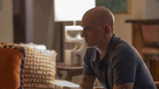 Anthony Carrigan as NoHo Hank, sitting in a living room, in Barry season 4