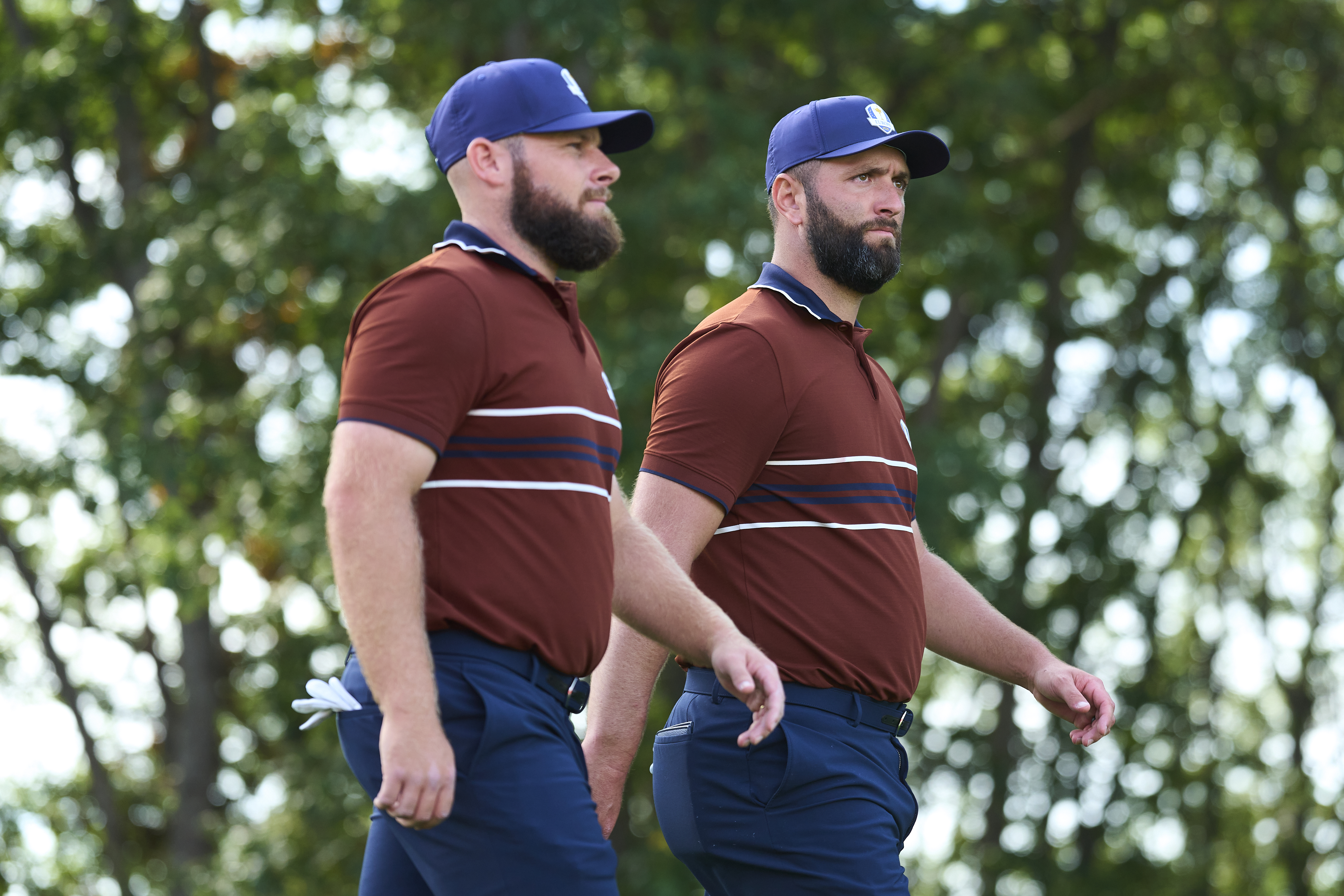 Tyrrell Hatton and Jon Rahm walk down the fairway