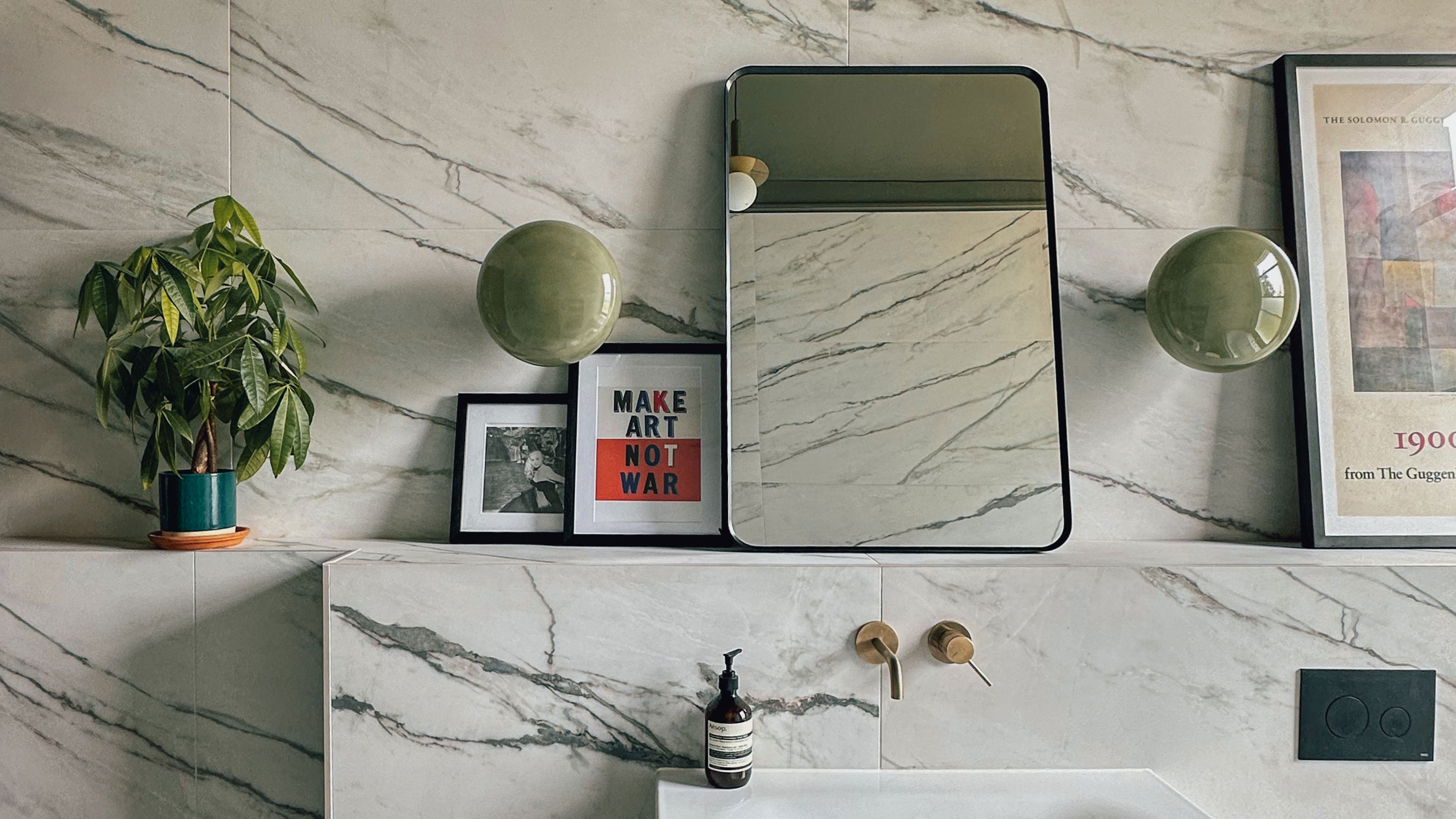 Tiled walls and shelving with artwork and mirror