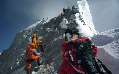 Climbers go up Mount Everest.