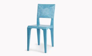 Light blue chair with marble style pattern photographed against a white background