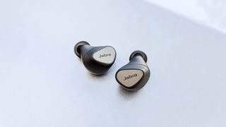Jabra Connect 5T earbuds on a white surface