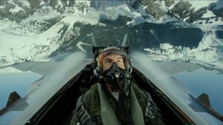 Tom Cruise in a plane&#039;s cockpit flying over mountains