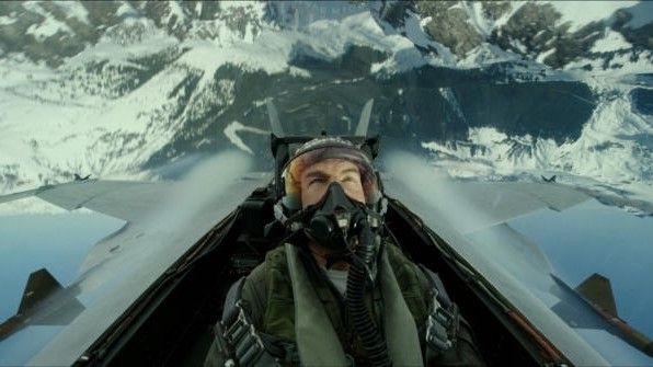 Tom Cruise in a plane&#039;s cockpit flying over mountains