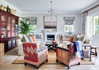 White living room with multicoloured patterned chairs, wicker carpet