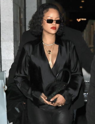 Rihanna wears zip-up leggings and a stain top