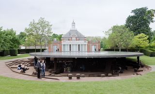 Structure in the Serpentine Gallery garden with a ground level roof and steps and walls dug into the ground