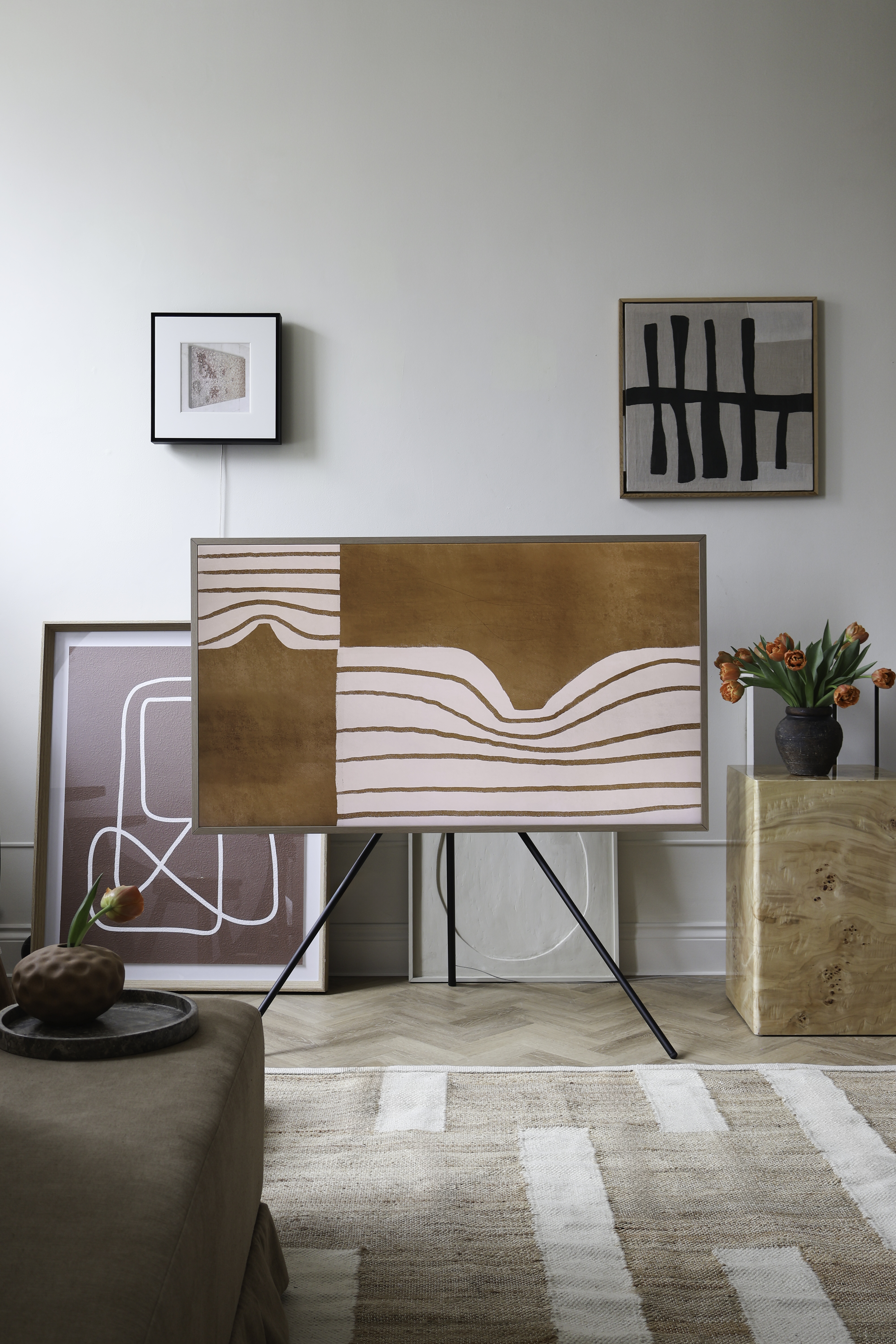 a samsung the frame tv on a stand in a characterful living space