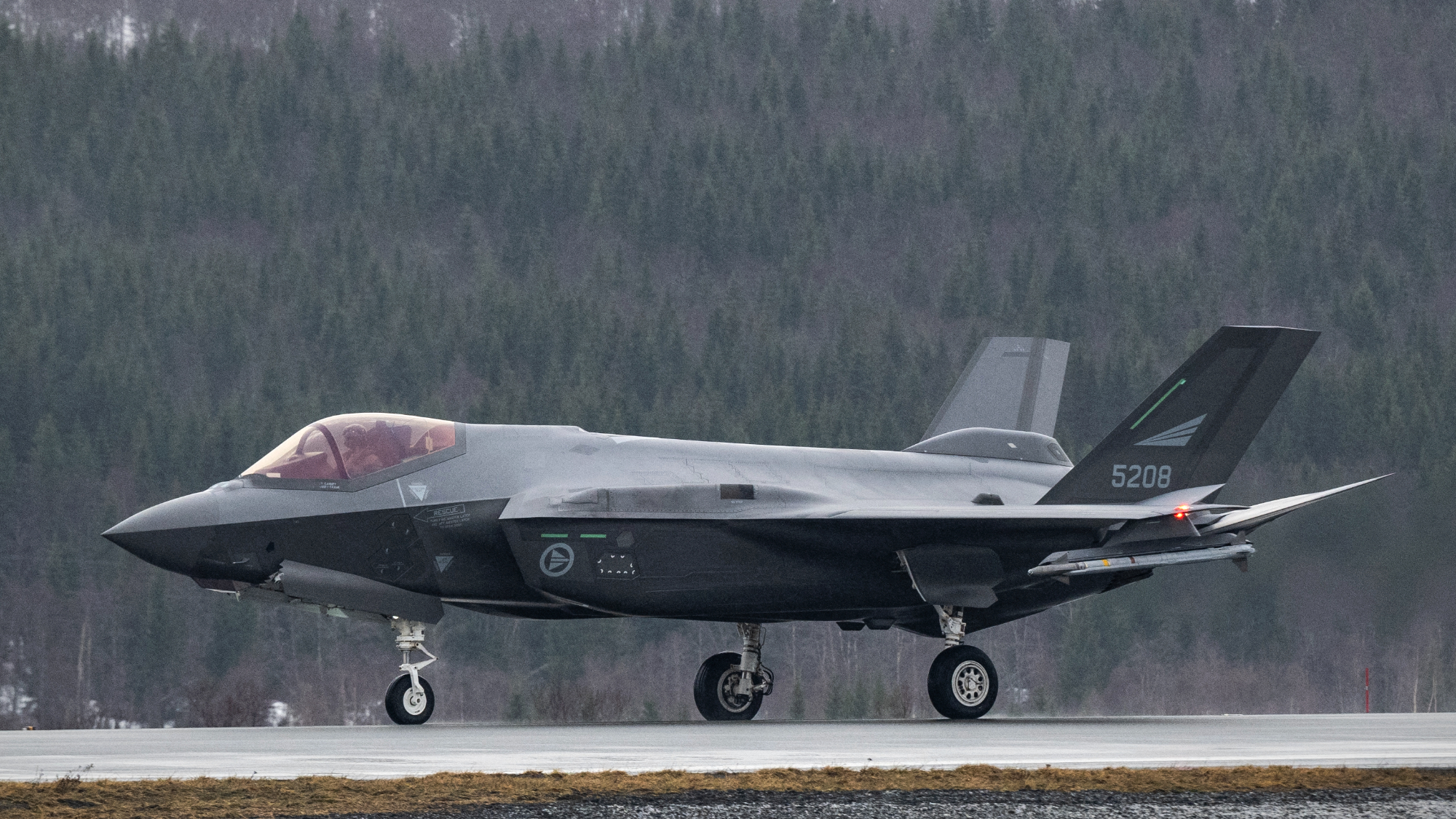 A US-made F-35 fighter aircraft of the Royal Norwegian Air Force lands at Evenes Airbase, near Narvik on March 11, 2026, as NATO conducts its Cold Response military exercise.
