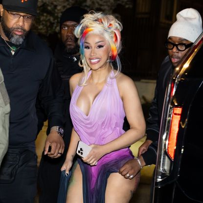 a paparazzi photo of cardi b wearing blonde hair with colorful streaks