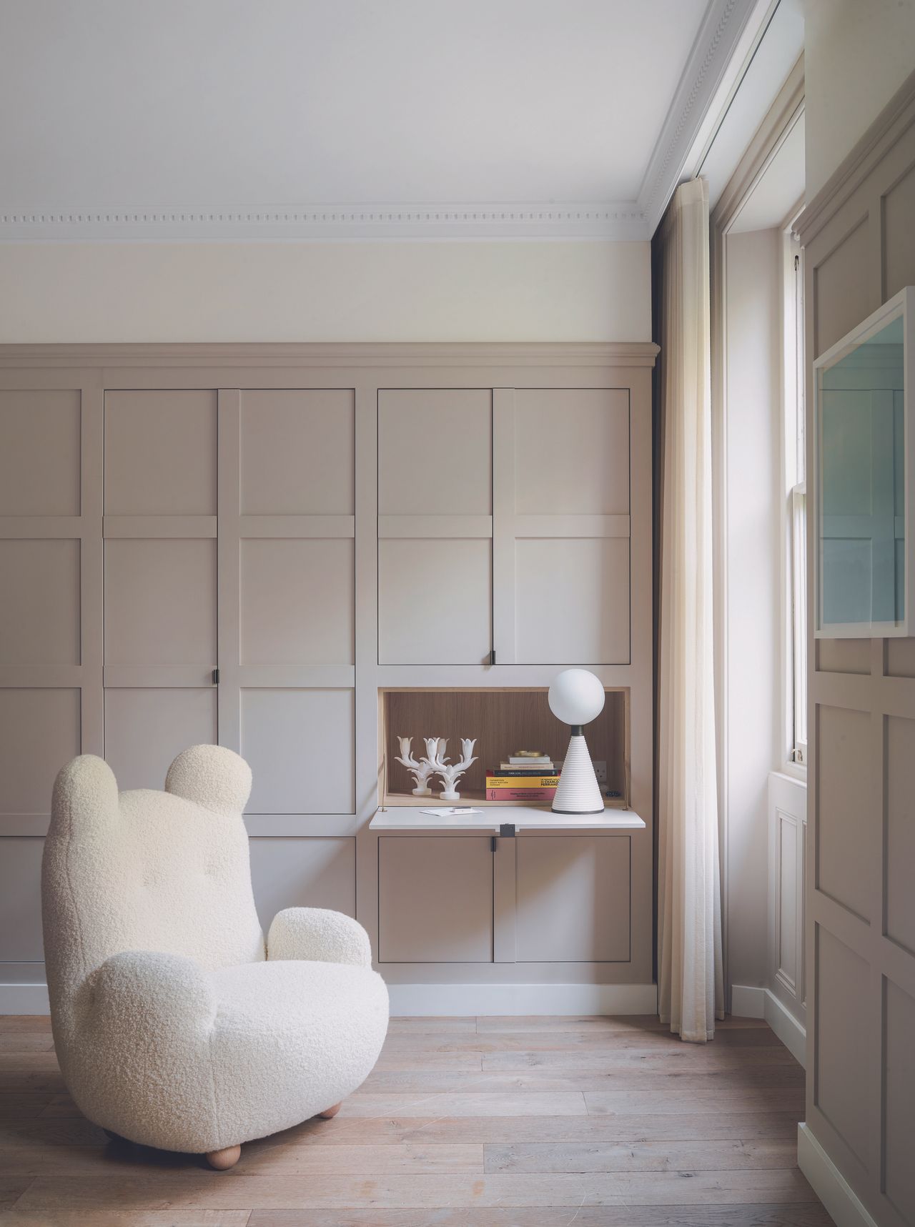 A panelled living space with a feature Papa Bear chair by Pierre Yovanovitch