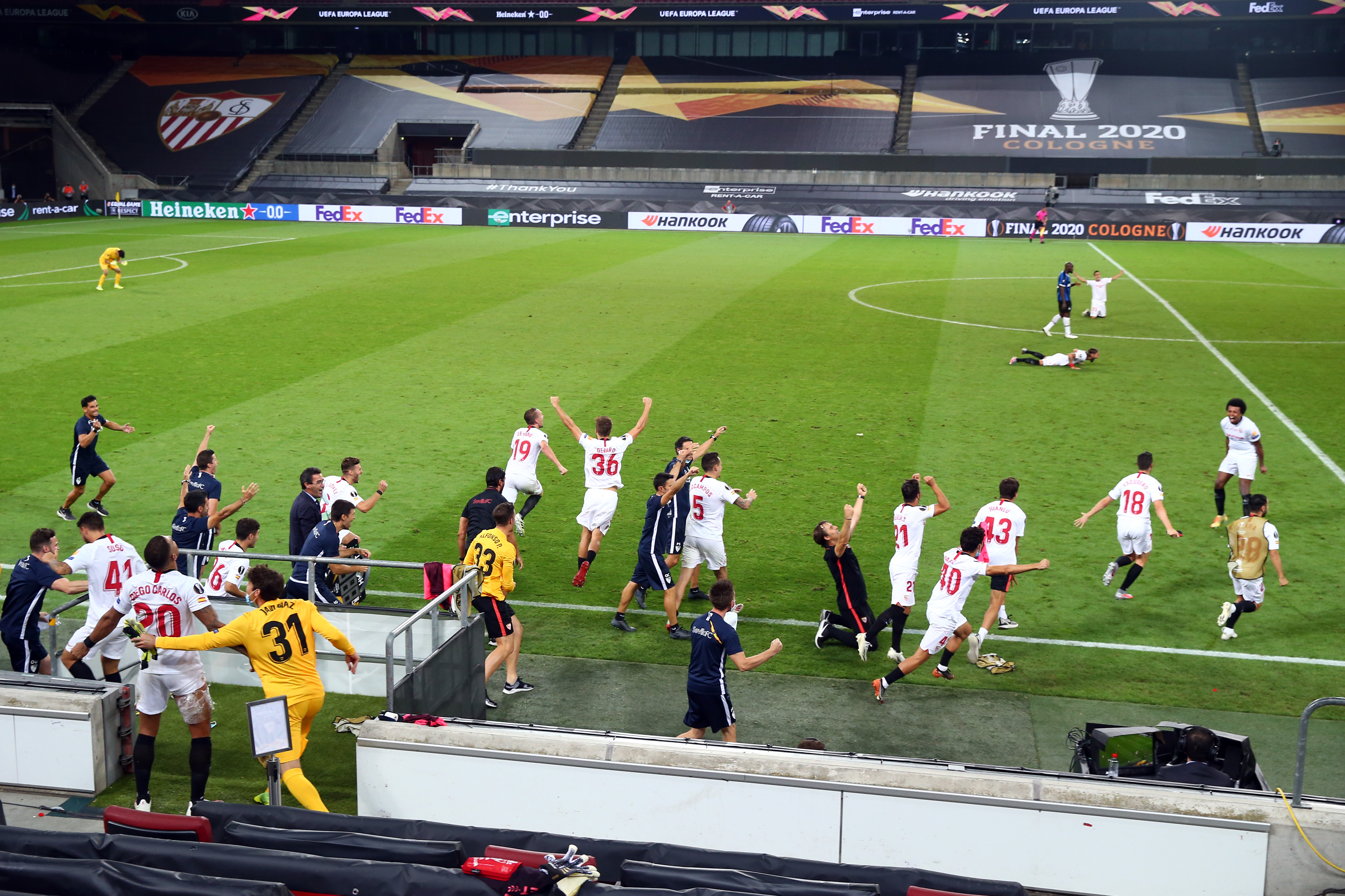 Sevilla players and staff celebrate victory against Inter in the 2020 Europa League final in Cologne.