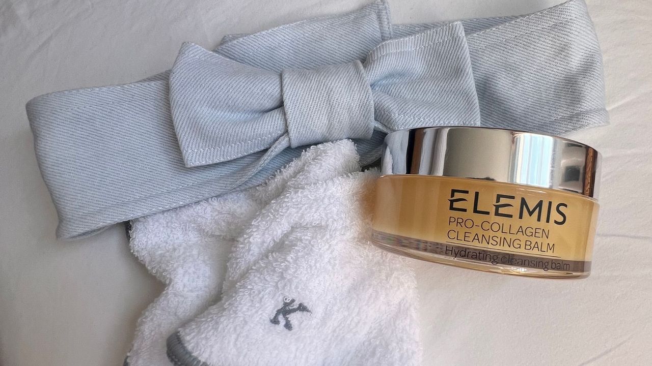 flatlay of the elemis cleansing balm, a personalised flannel and a headband