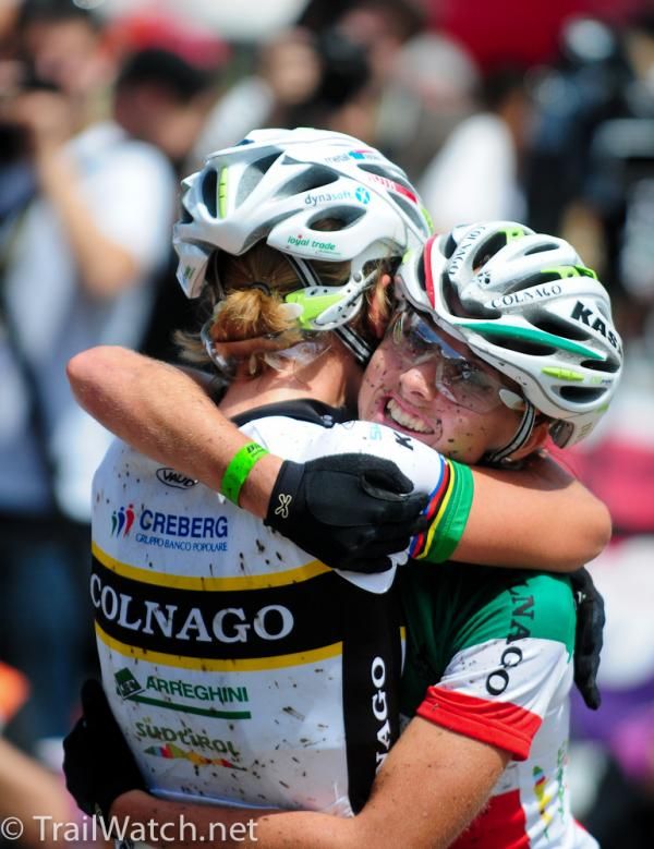 Teammates Nathalie Schneitter and Eva Lechner embrace at the finish