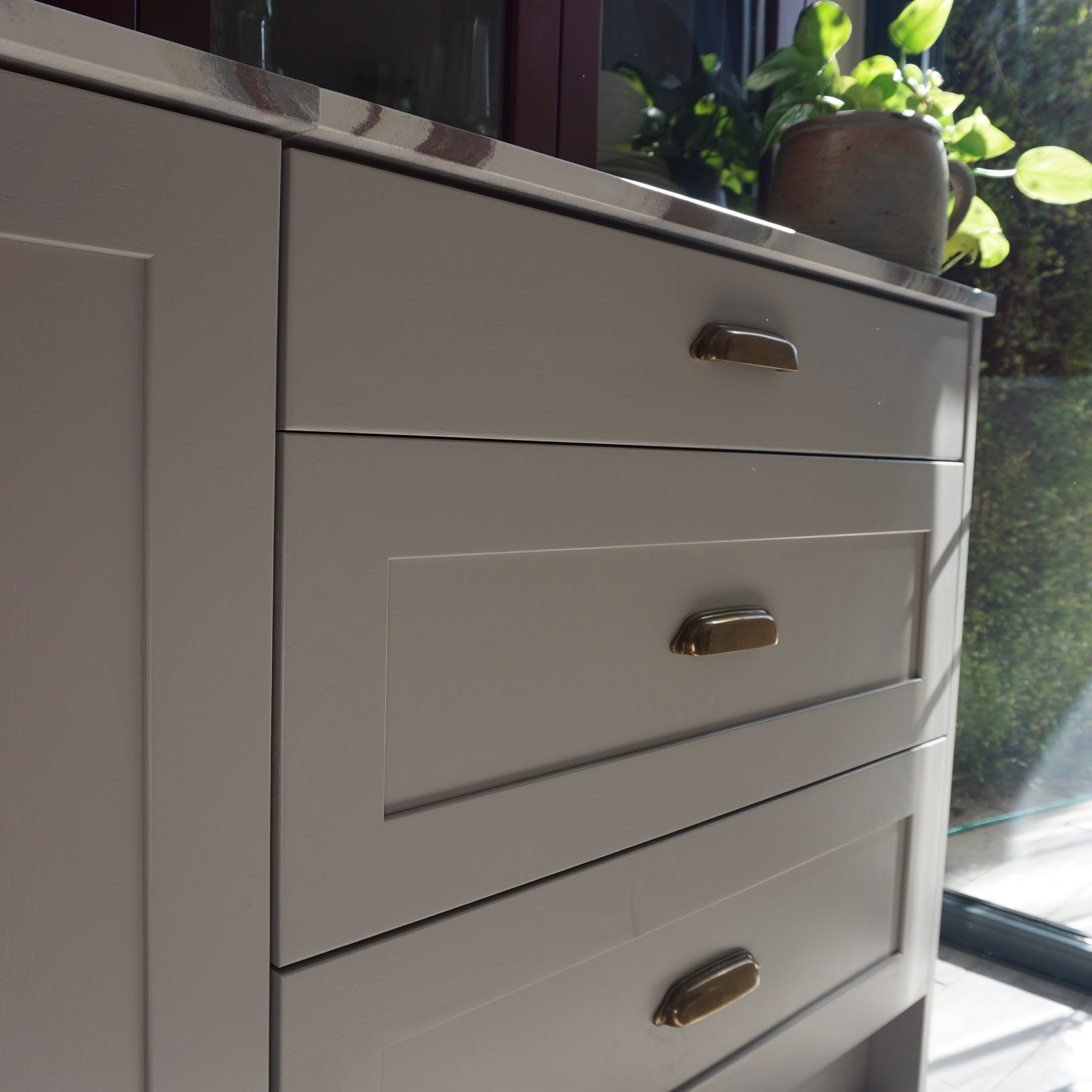 Close up of deep kitchen drawers with brass pull