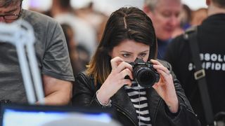 Someone testing out an Olympus camera at The Photography Show