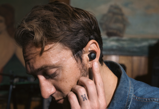 an image of a man wearing the JBuds ANC 3 True Wireless Earbuds