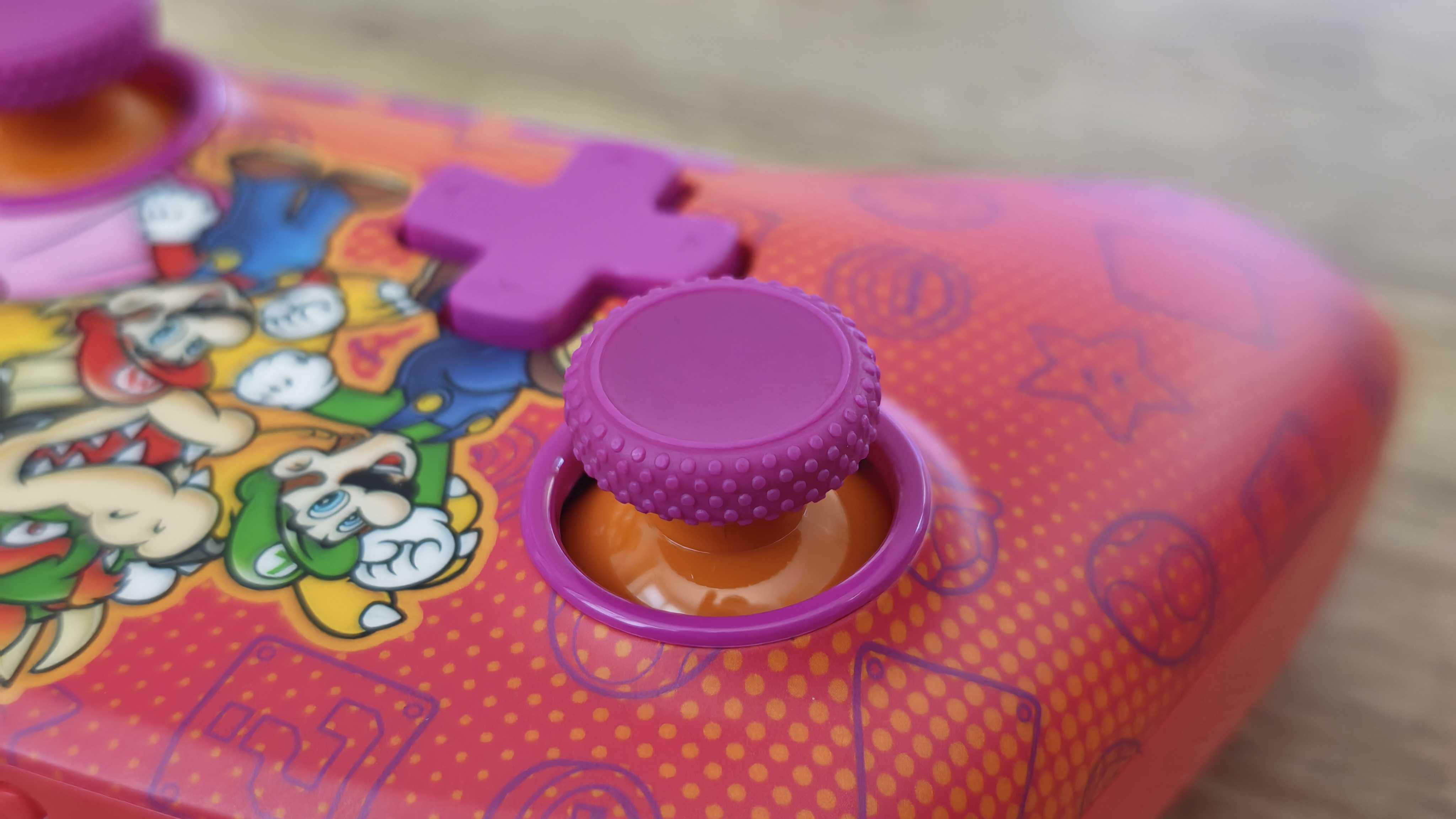 The PowerA Advantage Wireless Controller for Nintendo Switch 2 on a wooden table surface.