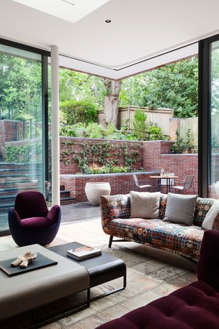 a corner patio door opening out to a brick-walled garden