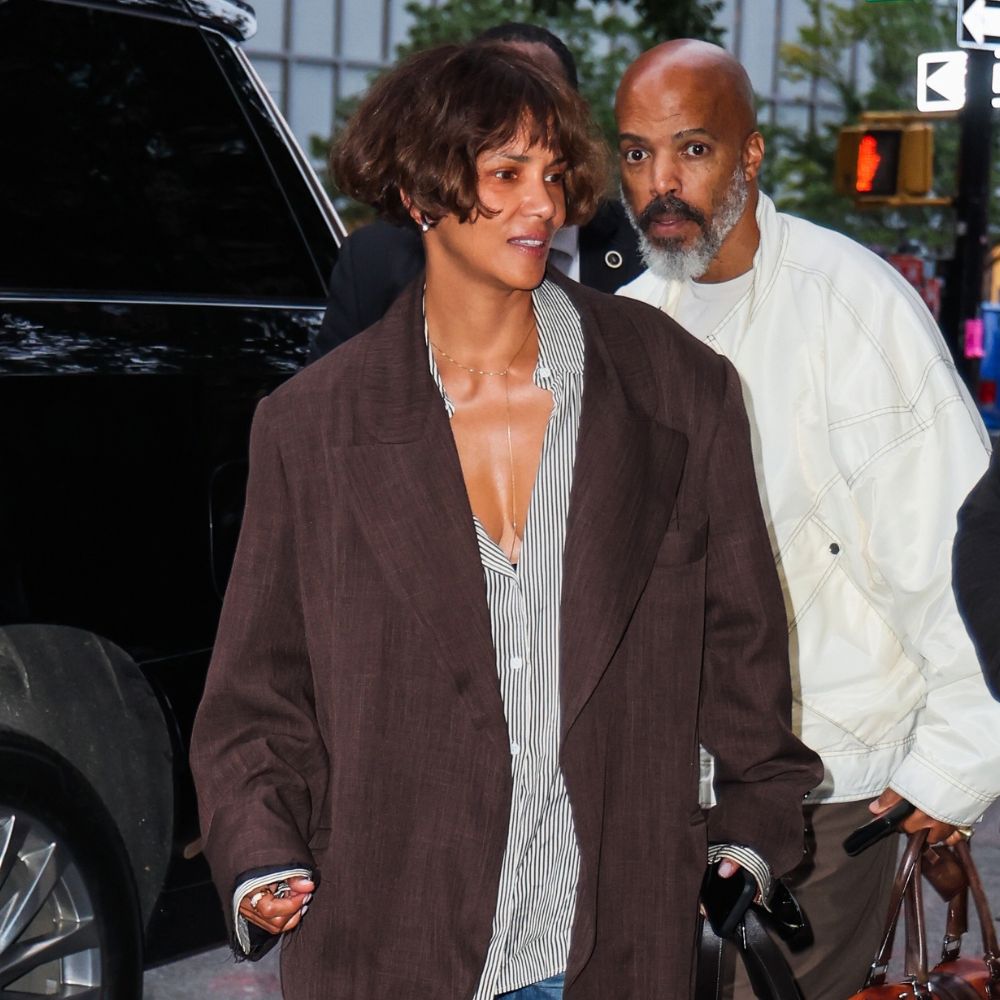 Halle Berry steps out of a car wearing an oversized blazer with cropped barrel-leg jeans, white trainers and an oversized shirt.