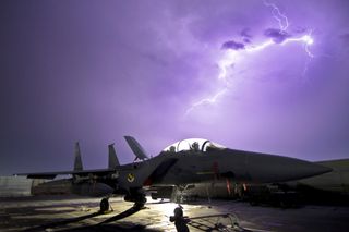 Strike Eagle Aircraft Illuminated by Lightning