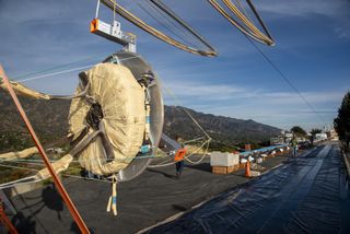 A closeup view of a parachute bag containing one of the two test parachutes of the ExoMars 2020 mission using a NASA test rig powered by compressed air. The image shows the new configuration of the parachute bag, which releases the parachute from the center outward, with the bag opening in a petal-like fashion.