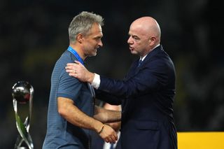 FIFA President, Gianni Infantino congratulates Christian Wuck, Head Coach of Germany, following the FIFA U-17 World Cup Final match between Germany and France at Manahan Stadium on December 02, 2023 in Surakarta, Indonesia.