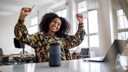 woman looking happy after using wireless technology for shopping on deal sites.