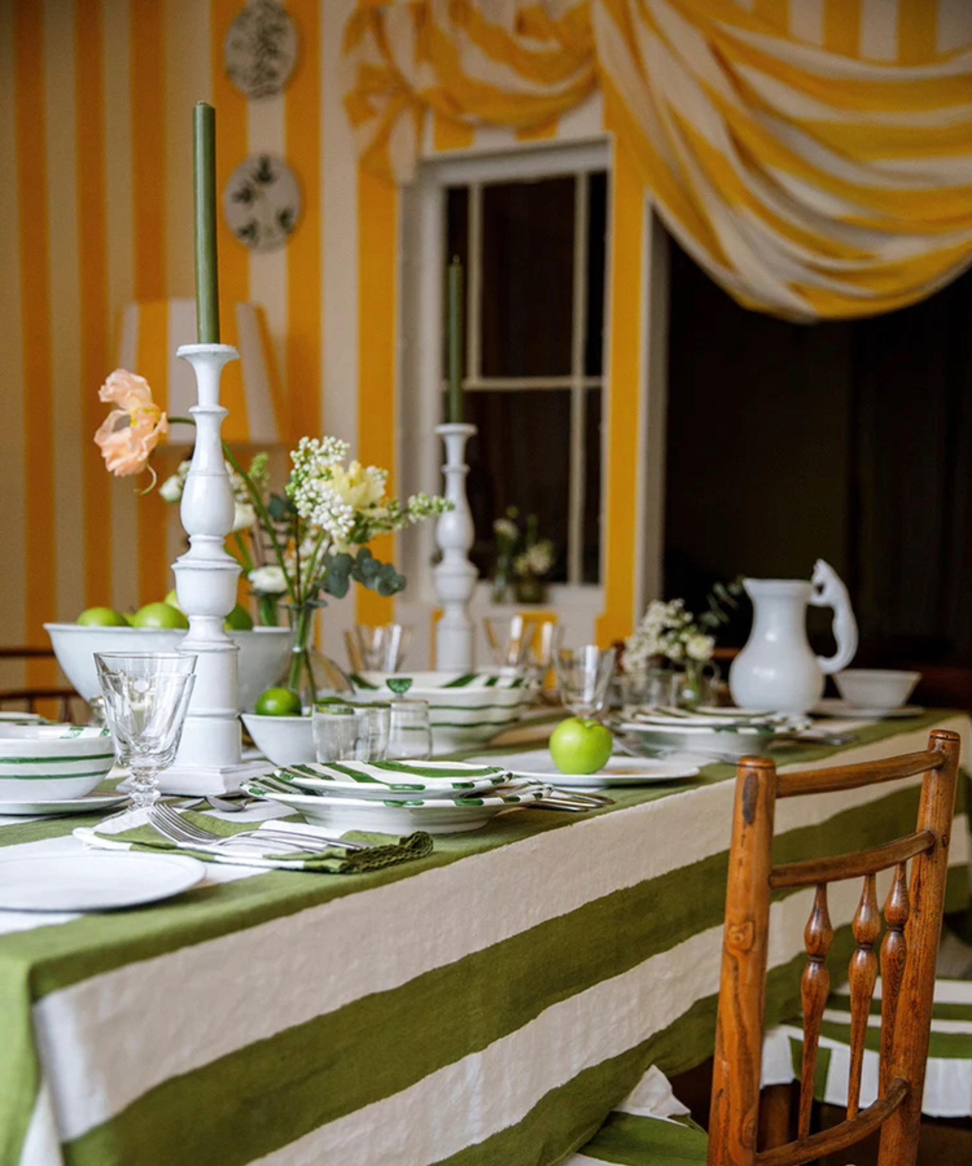 Striped green and white tablecloth in a dining room