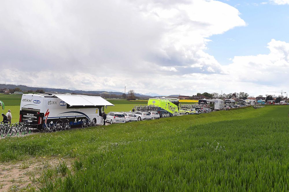 Team vehicles line the road at Tour de Romandie
